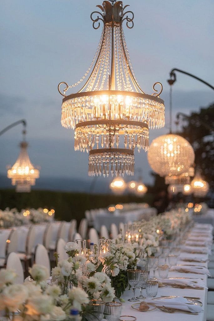 crystal chandeliers with white green and gold color palette for a luxury wedding dinner table