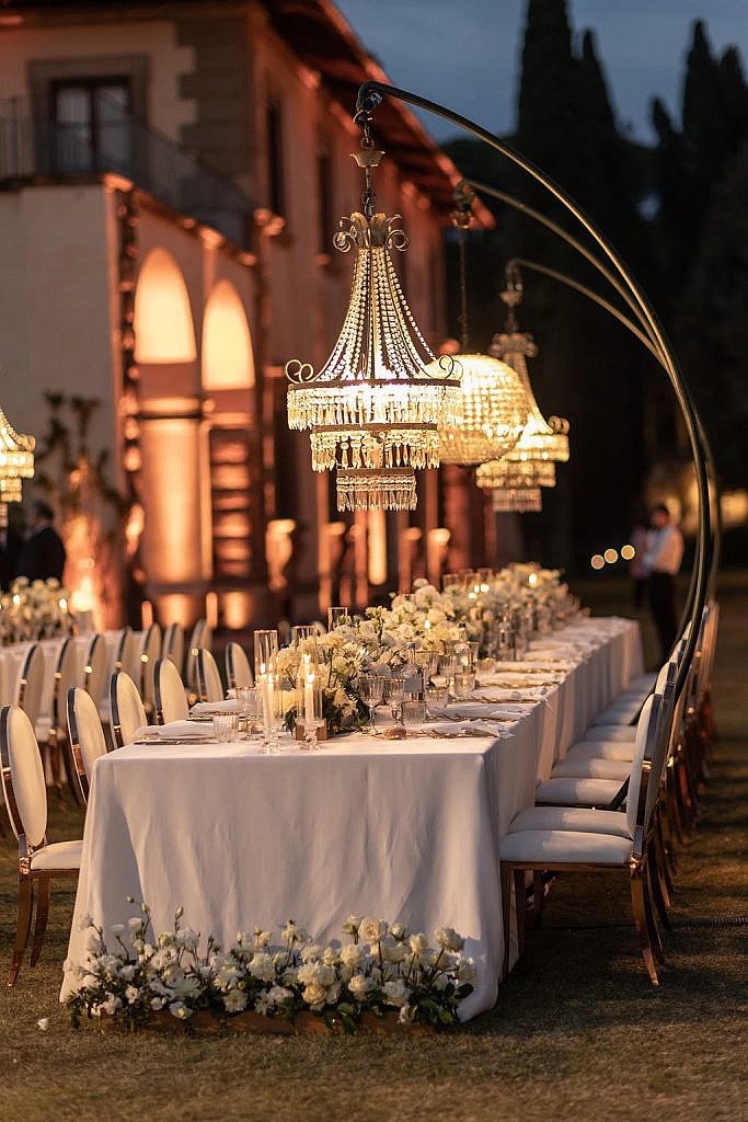 crystal chandeliers with white green and gold color palette for a luxury wedding dinner table