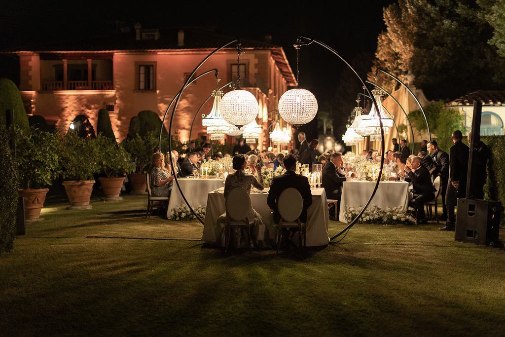 crystal chandeliers with white green and gold color palette for a luxury wedding dinner in villa gamberaia in florence