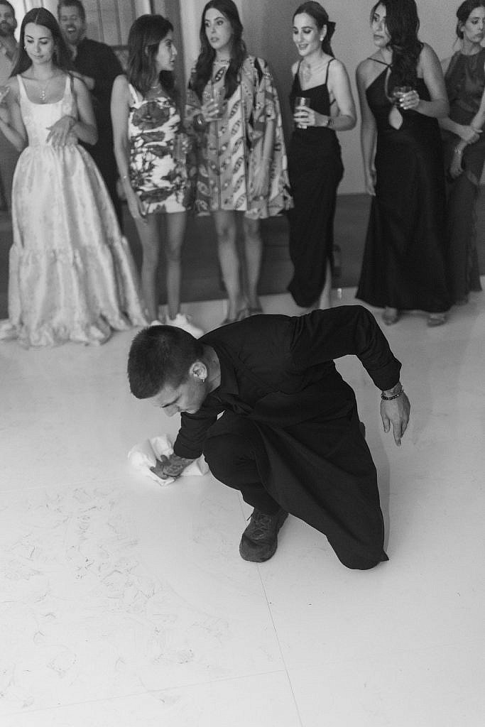 waiter cleaning the dancing floor during a real wedding party in villa gamberaia